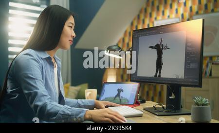 Asiatische weibliche 3D Designerin macht Animation für Videospiel Charakter mit modernen Computer und Tablet und Software für die Erstellung von 3D Modellierungs-Projekte Stockfoto