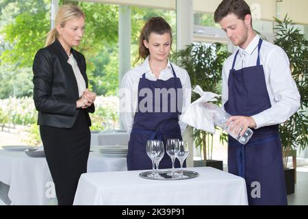 Junge Kellner und Kellnerinnen auf dem Tisch Stockfoto