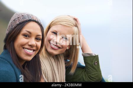 Kostbare Momente mit meinem besten Freund. Zwei junge Frauen sitzen draußen zusammen. Stockfoto