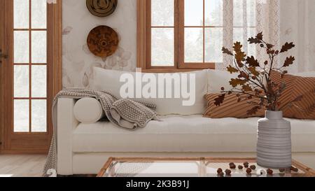 Vintage-Wohnzimmer in Weiß- und Beigetönen in Nahaufnahme. Sofa, Rattantisch mit Herbstdekoren. Vase mit trockenen Blättern und Eicheln. Boho Chic Design, Fall i Stockfoto