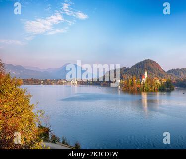 Atemberaubende Aussicht auf den Sonnenuntergang über dem beliebten Touristenziel Bled See. Dramatische Ansicht der Wallfahrtskirche Mariä Himmelfahrt. Lage: Bled, Uppe Stockfoto