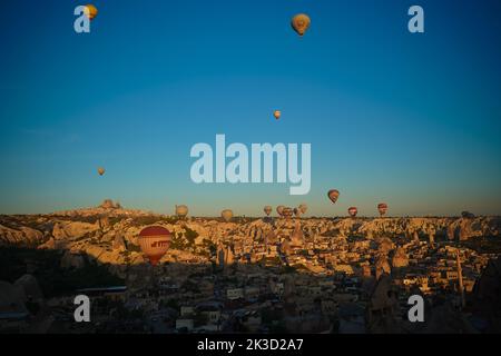 Sonnenaufgang Panoramablick auf Goreme, Uchisar Stadt und fliegende Ballons über Taubental Kappadokien, Türkei Stockfoto