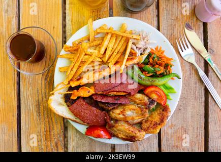 Verschiedene Fleischsorten mit Gemüse und pommes frites. Türkische Küche Stockfoto