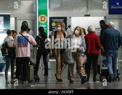 Richmond, Kanada. 26. September 2022. Reisende mit Gesichtsmasken werden am 26. September 2022 am Vancouver International Airport in Richmond, Kanada, gesehen. Die kanadische Bundesregierung kündigte am Montag die Aufhebung aller COVID-19-Einreisebeschränkungen sowie der Prüf-, Quarantäne- und Isolationsanforderungen für Personen an, die nach Kanada einreisen, mit Wirkung vom 1. Oktober an. Quelle: Liang Sen/Xinhua/Alamy Live News Stockfoto