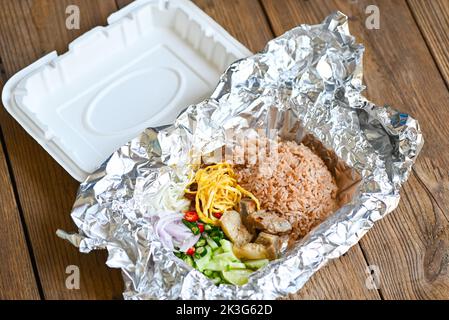 Thai-Lebensmittel auf Box mit Aluminiumfolie Lebensmittelverpackung Essen zum Mitnehmen - Reis gemischt mit Garnelenpaste gebratener Reis auf Box, Reis gewürzt mit Garnelenpaste Rezept, r Stockfoto