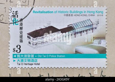 HONGKONG - UM 2013: Eine in Hongkong gedruckte Marke zeigt die Revitalisierung historischer Gebäude, cicra 2013. Stockfoto