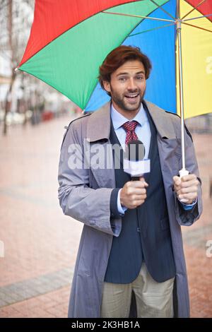 Und es sieht aus wie Regen heute Leute. Ein lächelnder Wettermann, der aus einem städtischen Gebiet berichtet. Stockfoto