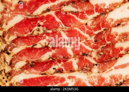 Schinken. Schinkenscheiben in Nahaufnahme. Schweinefleisch, Hintergrundstruktur Stockfoto