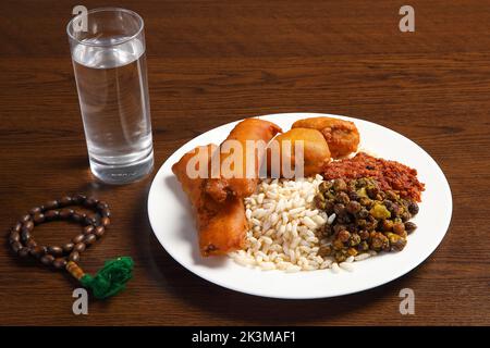 Ramadan Kareem und iftar muslimisches Essen, Urlaubskonzept. Tabletts mit Nüssen und getrockneten Früchten und Laternen mit Kerzen. Stockfoto