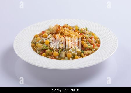 Mein Lieblings-Chotpoti im Rahmen, pikante Chana Chat Masala Chotpoti in einem schwarzen Gericht, isoliert im Hintergrund mit Blick von oben auf indisches, bangali und pakistanisches Essen Stockfoto