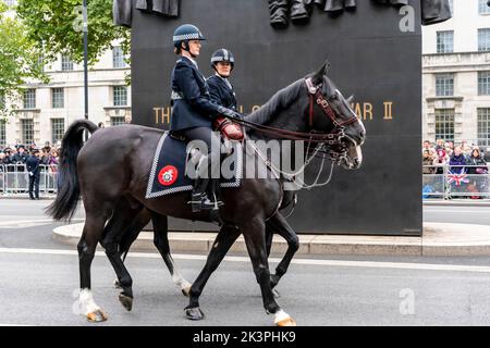 Berittene weibliche Polizeibeamte passieren das Women of World war Two Monument in Whitehall, London, Großbritannien. Stockfoto