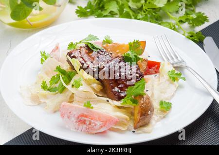 Leckerer Salat mit Fleischkartoffeln, Tomaten und Mayonnaise-Sauce Stockfoto