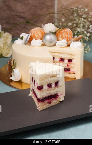Süßes Stück Milchkuchen mit Kirschen und weißer Schokolade Stockfoto