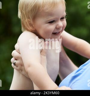 Er liebt seine Mama so sehr. Ein kleiner Junge, der mit seiner Mutter spielt. Stockfoto