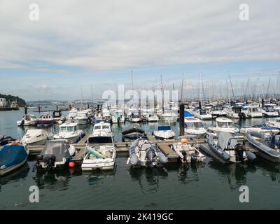 Blick über die Brixham Marina attraktiver Fischerort Brixham Devon England an der englischen Riviera mit Motorbooten, die gegen Pontons festgemacht sind Stockfoto