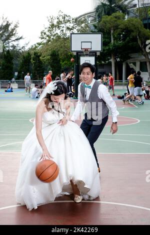 Braut und Bräutigam spielen Basketball Stockfoto