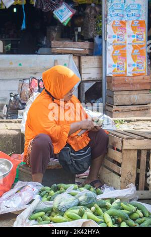 Pandeglang, Banten, Indonesien - 15. November 2020 : eine Mutter, die nach einem Vermögen sucht, das Gemüse auf traditionellen Märkten oder allgemein genannt verkauft Stockfoto