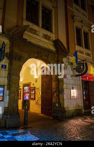 PRAG, TSCHECHISCHE REPUBLIK - 04. MÄRZ 2022: Der alte Bogen in einem mittelalterlichen Gebäude in der Celetna-Straße, der zum authentischen Restaurant führt, wurde am 04. März in Prag, Tschechische Republik, errichtet Stockfoto