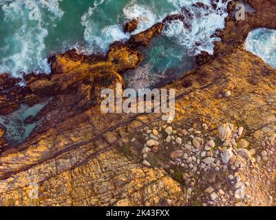 Blick auf die Meereswellen und die Küste mit felsigen Klippen Stockfoto