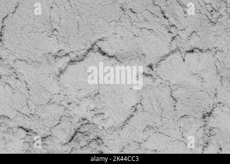 Abstrakter grauer Hintergrund. Nahaufnahme der trockenen Stuckstruktur. Stockfoto