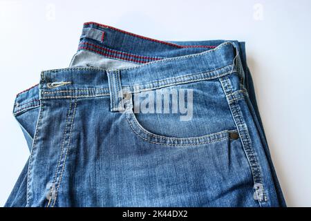Fragment einer Jeans mit einer Tasche. Lässige Kleidung. Ursprünglicher Hintergrund für das Design. Stockfoto