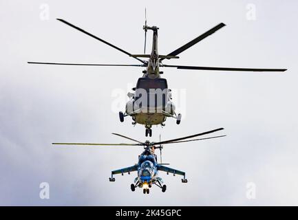 Zwei Militärhubschrauber, die Kunstflug machten, russische machten Mil Mi 17 und Mil Mi 24,35 Hind Chopper mit der tschechischen Luftwaffe, auf der Duxford Airshow, Großbritannien Stockfoto