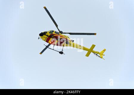 Airbus Helicopters H125 HB-ZMY der Heli Bernina AG im Flug bei Schneefall, St. Moritz, Graubünden, Schweiz Stockfoto