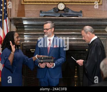 Washington, Vereinigte Staaten Von Amerika. 30. September 2022. Washington, Vereinigte Staaten von Amerika. 30. September 2022. Ketanji Brown Jackson, Associate Justice des Obersten Gerichtshofs der Vereinigten Staaten, nimmt den Amtseid vom Obersten Richter John Roberts, rechts, ab, während ihr Mann Dr. Patrick Jackson während der feierlichen Investitur im Justices Conference Room, 30. September 2022 in Washington, DC, anschaut. Quelle: Fred Schilling/Collection of the Supreme Court of the United States/Alamy Live News Stockfoto