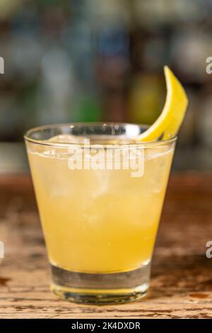 Penicillin-Cocktail an der Bar. Verschwommener Hintergrund.erfrischendes Getränk im Sommer, Seitenansicht, Nahaufnahme. Stockfoto