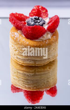 vol au vent mit Heidelbeere, Blätterteig gefüllt mit Beeren auf einem Spiegel Stockfoto