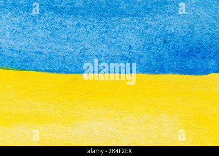 Flagge der Ukraine mit Aquarellen gemalt. Makro-Nahaufnahme der blauen und gelben Aquarellmalerei. Texturierter Aquarellpapierhintergrund mit Kopierbereich. Stockfoto