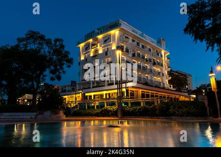 Von außen ein wunderschönes, modernes Hotel mit Balkonen in der Nacht. Modernes Wohnapartmentgebäude außen. Stockfoto