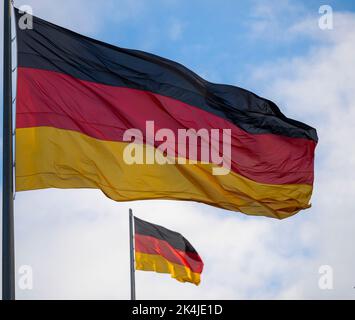 Berlin, Deutschland. 03. Oktober 2022. Die deutschen Flaggen am Reichstagsgebäude, dem Sitz des Deutschen Bundestages, winken im Wind. Quelle: Monika Skolimowska/dpa/Alamy Live News Stockfoto