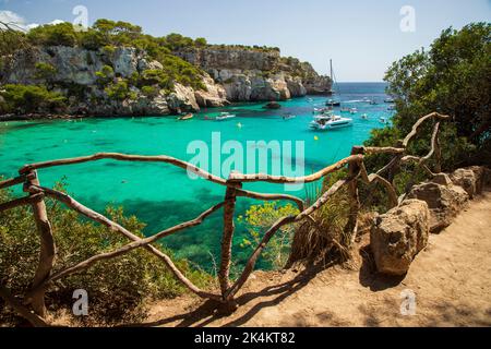 Menorca, Spanien - 1.. September 2022: Am Strand von Macarella schwimmen die Menschen gerne auf den Booten Stockfoto