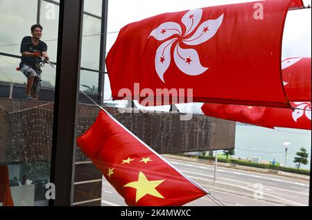 Arbeiter stellten die chinesische Nationalflagge und die Hongkonger Flagge auf, um den 73.. Jahrestag der Gründung der Volksrepublik China in Tsim Sha Tsui zu feiern. 29SEP22. SCMP/May Tse Stockfoto