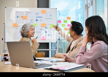 Eine Gruppe professioneller asiatischer Geschäftsleute trifft sich und plant gemeinsam ihren Finanzmanagementplan für Unternehmen. Stockfoto