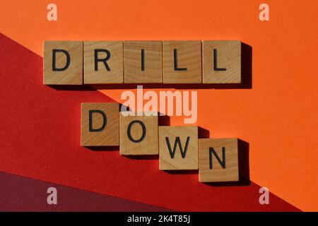 Drill-Down, Wörter in Holzalphabetbuchstaben isoliert auf dem Hintergrund, Buzzword Bedeutung, um etwas weiter zu erforschen oder zu erforschen, auf einer tieferen Ebene Stockfoto