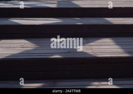 Holztreppe mit Schatten aus nächster Nähe Stockfoto