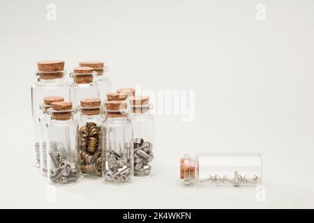 Glas Gläser mit Kork, Organisation der Nägel Schrauben, Nüsse mit weichem grünen Hintergrund Stockfoto