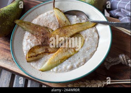 Haferbrei mit gerösteten Birnen und Zimt Stockfoto