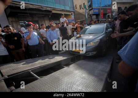 Nablus, Palästina. 4. Oktober 2022. Palästinensische Sicherheitskräfte bringen ein Auto jüdischer Siedler in die Stadt Nablus im besetzten Westjordanland. Palästinensische Schützen entführten vier Siedler, während sie sich mitten auf einem Markt in der Stadt Nablus im Westjordanland befanden. Die Palästinensische Autonomiebehörde übergab sie der israelischen Seite ohne Schäden oder Verletzungen. (Bild: © Nasser Ishtayeh/SOPA Images via ZUMA Press Wire) Stockfoto
