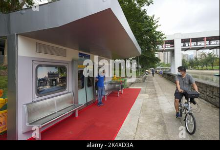 Sitze und Türen der Mid-Life Refurbished Trains (MLR), die im Mai von der East Rail Line des MTR ausgeschieden sind, wurden renoviert und in einem Sitzbereich am Lam Tsuen River in Tai Po zu einem Regenschutz umgebaut. Sie werden als Bestandteile eines neuen Sitzbereichs am Fluss in Tai Po neu erwacht. Es wird erwartet, dass sich die breite Öffentlichkeit auf diesen Sitzen ausruhen und die vergangenen Tage des Schienenverkehrs in Erinnerung bringen kann. 02OCT22 SCMP/Sam Tsang Stockfoto