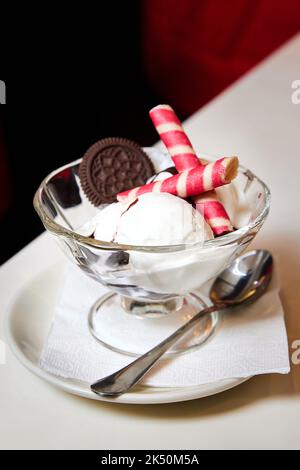 Cremige Eiskugeln mit Keksen in einem Glasbown Stockfoto