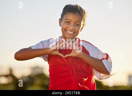 Herz Hand und Mädchen Porträt bei Fußballspiel mit leidenschaftlichen und glücklichen Sportspieler in Mexiko. Mexikanischer Kinder-Fußballathlet in der Spielvorzeige Stockfoto