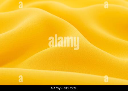 Nahaufnahme lange und breite Textur aus natürlichem gelbem Stoff oder Stoff in hellroter Farbe. Stoffstruktur aus Naturbaumwolle oder Leinenstoff. Yello Stockfoto