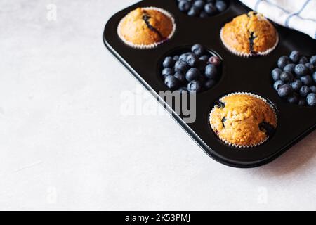 Heidelbeer-Muffins auf Marmorboden. Speicherplatz kopieren. Stockfoto