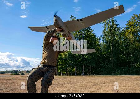 U.S. Marine Corps Sgt. Deakon Thornton, ein Geheimdienst-Spezialist bei der Aufklärungsabteilung mit leichter Panzerabwehr, Battalion Landing Team 2/6, 22. Marine Expeditionary Unit (MEU), startet während eines Objective Clearing Trainings in Ravlunda, Schweden, am 31. August 2022 ein unbemanntes Luftsystem von RQ20B Puma. Die Kearsarge Amphibious Ready Group und 22. MEU, unter dem Kommando und der Kontrolle der Task Force 61/2, befinden sich im geplanten Einsatzgebiet der US Naval Forces Europe, das von der US Sixth Fleet eingesetzt wird, um die Interessen der USA, der Alliierten und der Partner zu verteidigen. (USA Marine Corps Foto von Sgt. Armando Eli Stockfoto