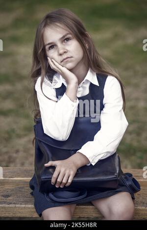 Lernen Sie zu denken. Ernsthaftes Kind mit nachdenklicher Optik. Kleine Schülerin in Gedanken verloren. Zurück zur Schule. Frühzeitige Bildung. Denken, um zu lernen. Problemlösung Stockfoto