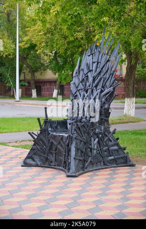 Ein cooler, funky, seltsamer Metall, Bronze, schwarzer Stuhl, Thron, aus dem Zusammenweben von Schwertern. In Astana, Nursultan, Kasachstan. Stockfoto