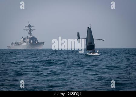 Arabischer Golf, Baharain. 07. Oktober 2022. Arabischer Golf, Baharain. 07. Oktober 2022. Ein unbemanntes Oberflächenschiff der US Navy Saildrone Explorer segelt mit dem Arleigh Burke-Klasse Lenkraketen-Zerstörer USS Delbert D. Black während der Übung Phantom Scope im Arabischen Golf, 7. Oktober 2022 vor der Küste von Bahrain. Die eintägige gemeinsame Übung mit den Marines der USA und des Vereinigten Königreichs kombinierte unbemannte und bemannte Schiffe. Quelle: MCS Roland Franklin/US Navy/Alamy Live News Stockfoto